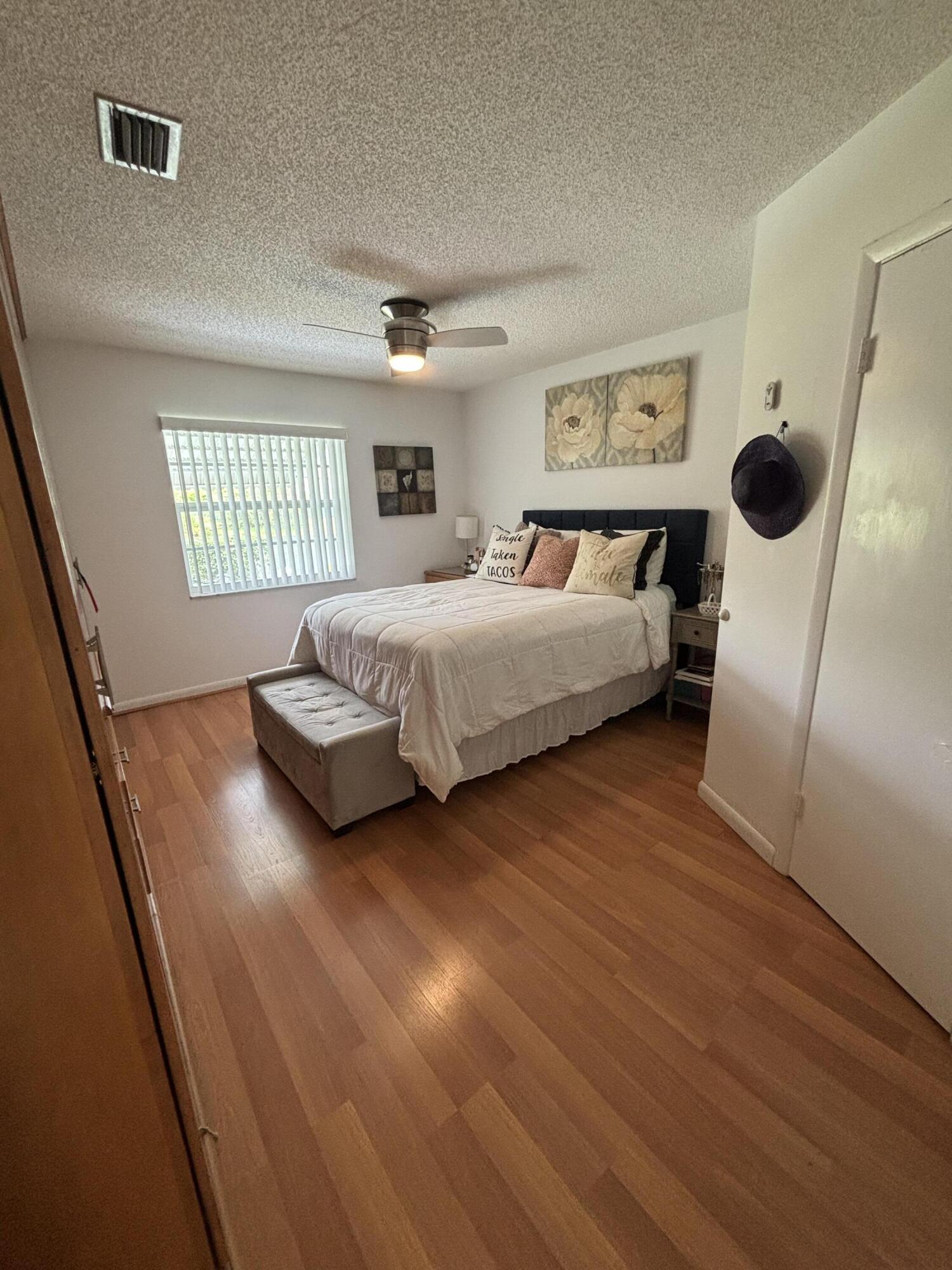 8833 Bella Vista Drive, Unit 8833 Boca Raton, FL 33433 - Photo 20 of 47 a spacious bedroom with a bed and a large window