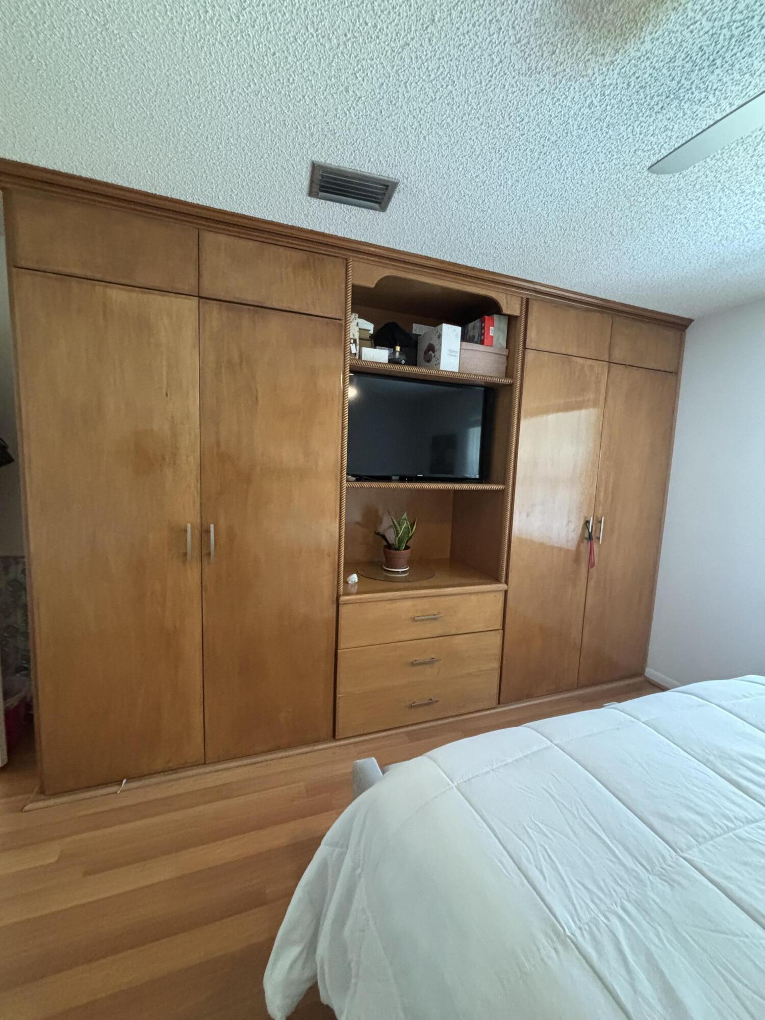 8833 Bella Vista Drive, Unit 8833 Boca Raton, FL 33433 - Photo 21 of 47 a bedroom with a bed and a closet