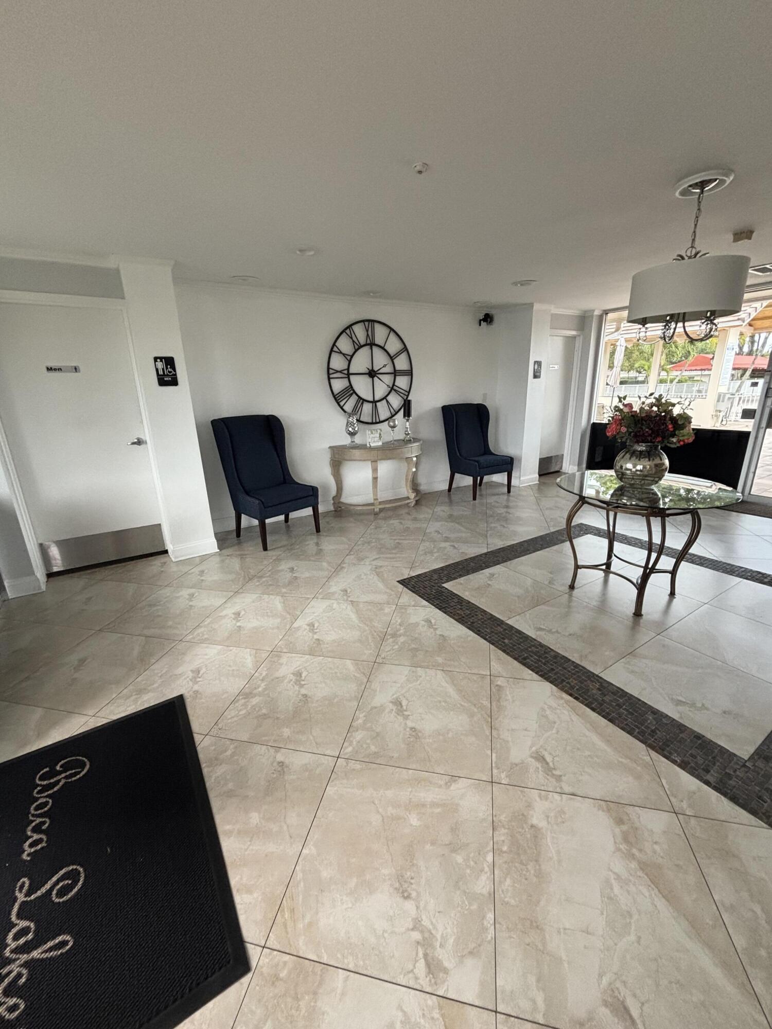 8833 Bella Vista Drive, Unit 8833 Boca Raton, FL 33433 - Photo 35 of 47 a living room with furniture a rug and a table
