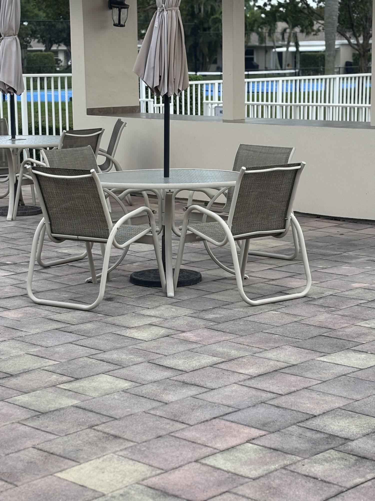 8833 Bella Vista Drive, Unit 8833 Boca Raton, FL 33433 - Photo 45 of 47 a view of a chairs and table on the deck
