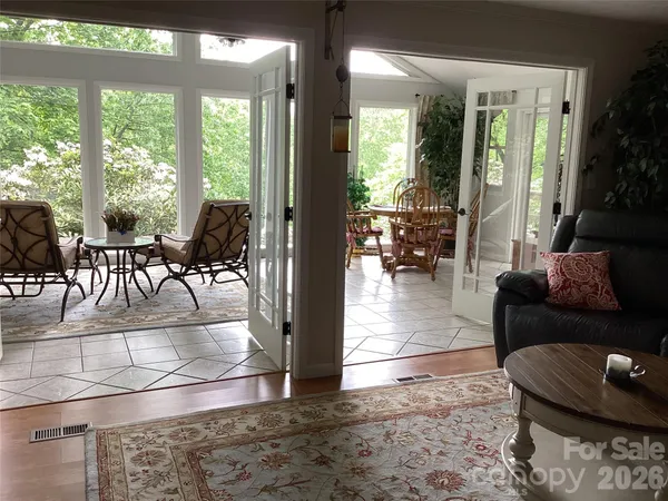 a view of a porch with chairs and backyard
