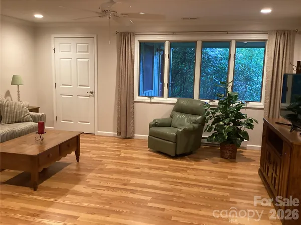 a living room with furniture and a book shelf