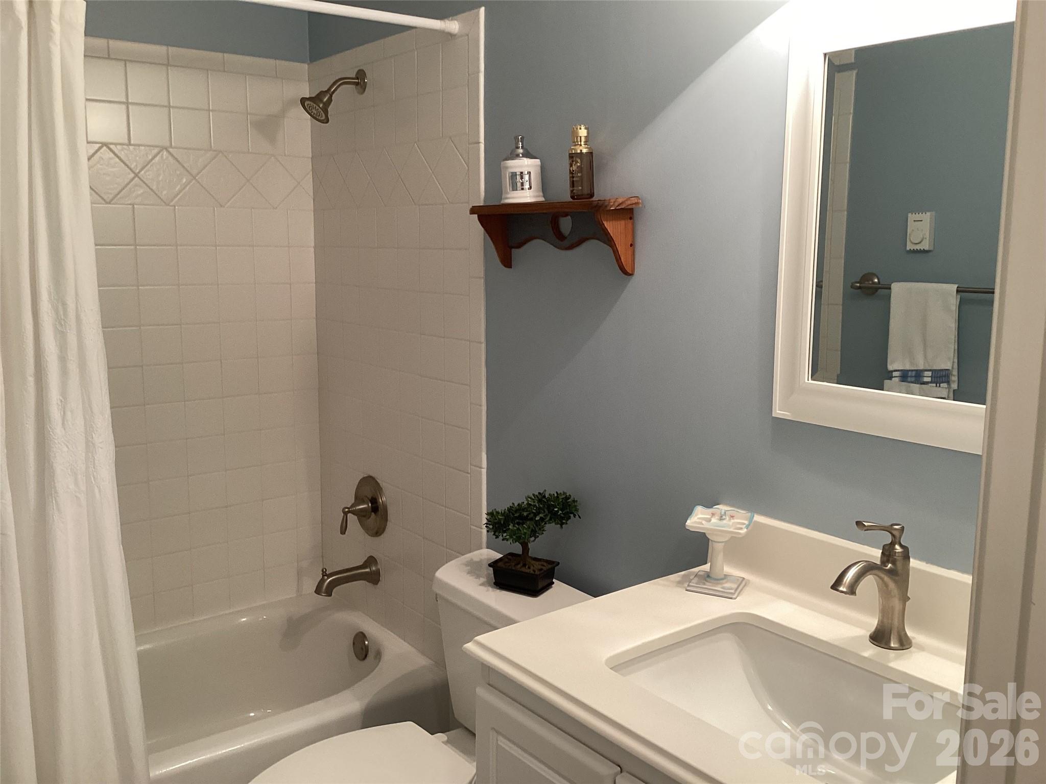 31 Rhododendron Road Black Mountain, NC 28711 - Photo 23 of 27 a bathroom with a sink and mirror with bathtub