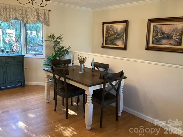 a dining room with a window and furniture