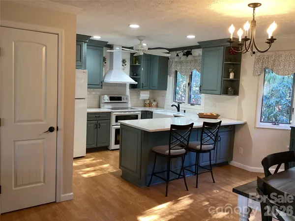 a kitchen with a sink a stove and cabinets