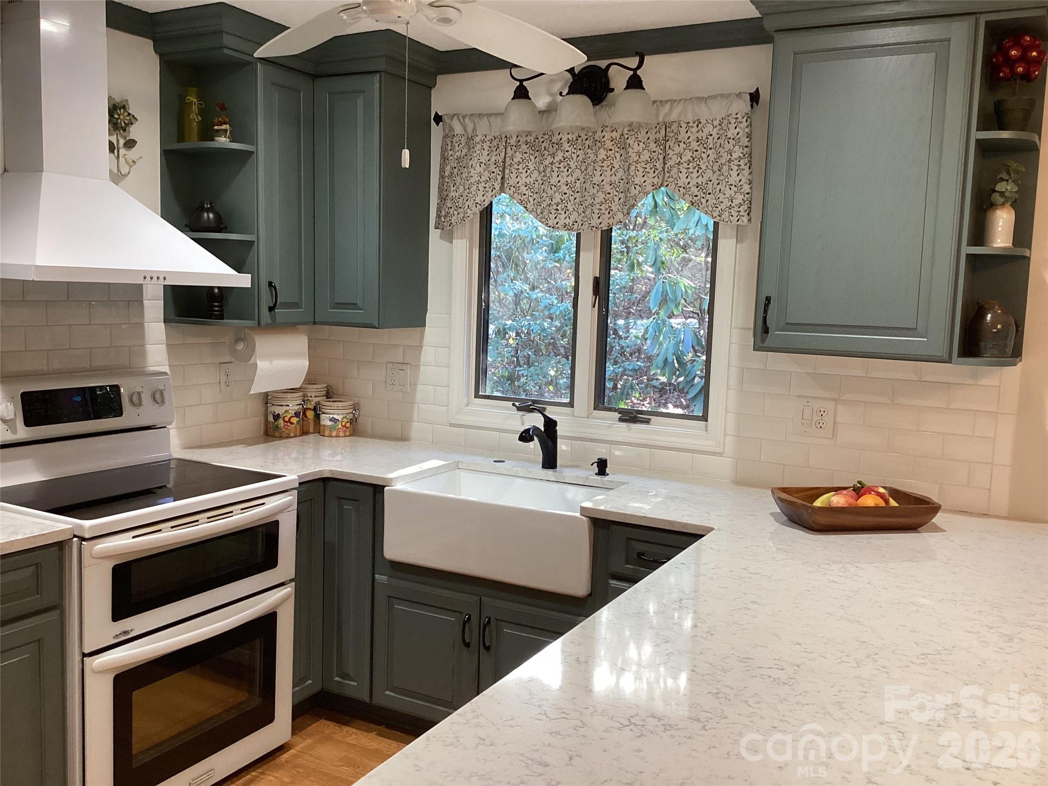 31 Rhododendron Road Black Mountain, NC 28711 - Photo 10 of 27 a kitchen with a sink a stove and cabinets
