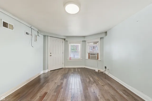 a view of room with window and wooden floor