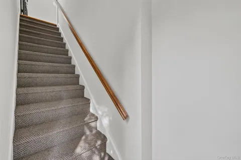 a view of a livingroom with wooden floor and a kitchen space