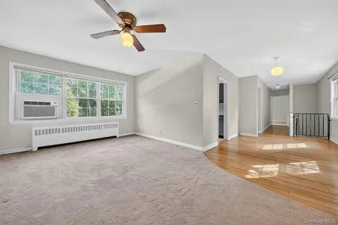 an empty room with a fireplace and fan