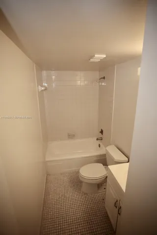 a bathroom with a toilet a sink and bathtub