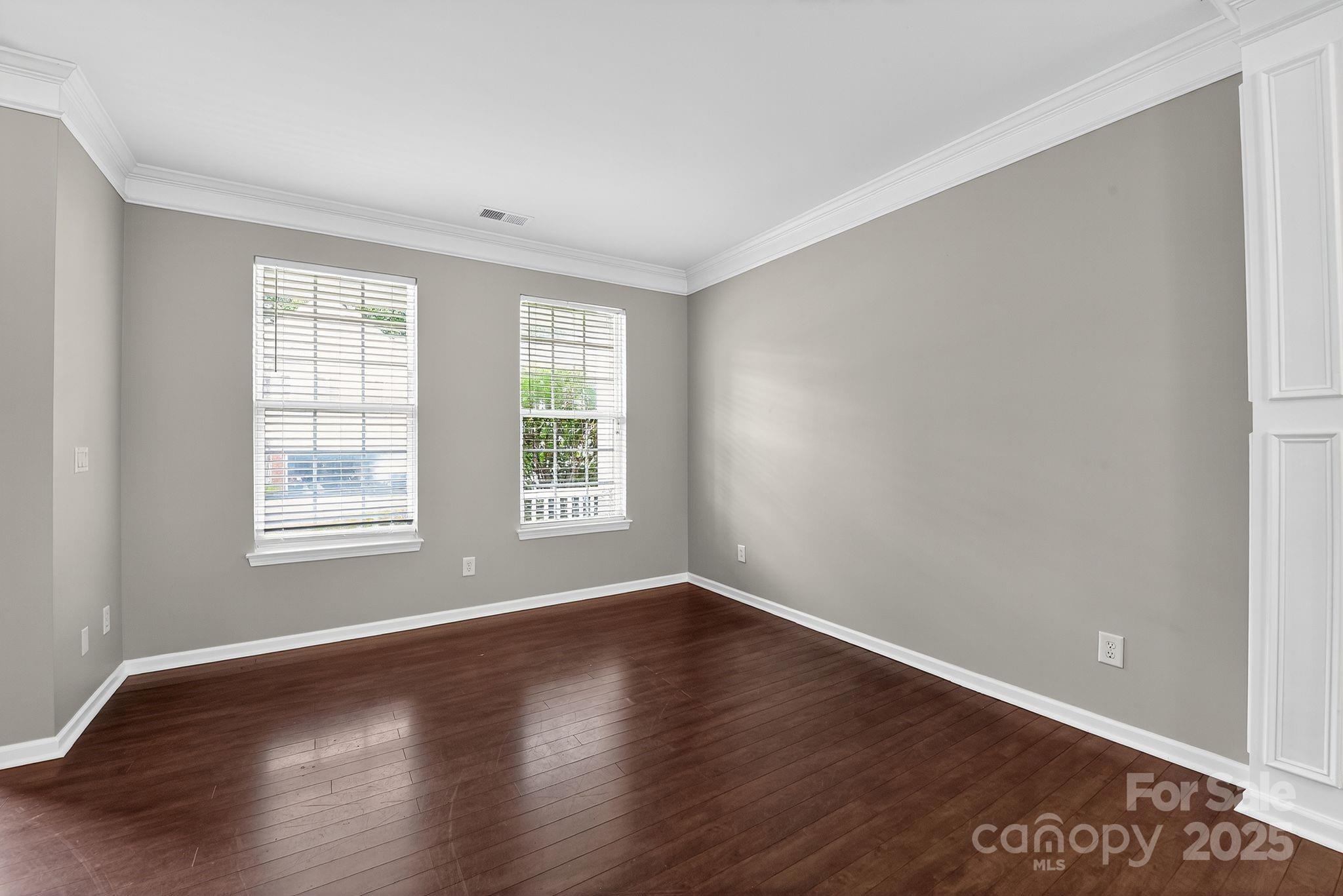 3114 Less Traveled Trail Indian Trail, NC 28079 - Photo 14 of 32 a view of an empty room with wooden floor and a window