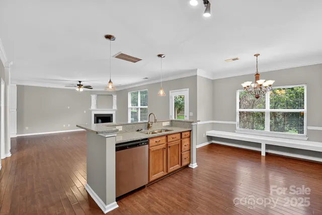a view of kitchen with stainless steel appliances granite countertop a stove and a refrigerator