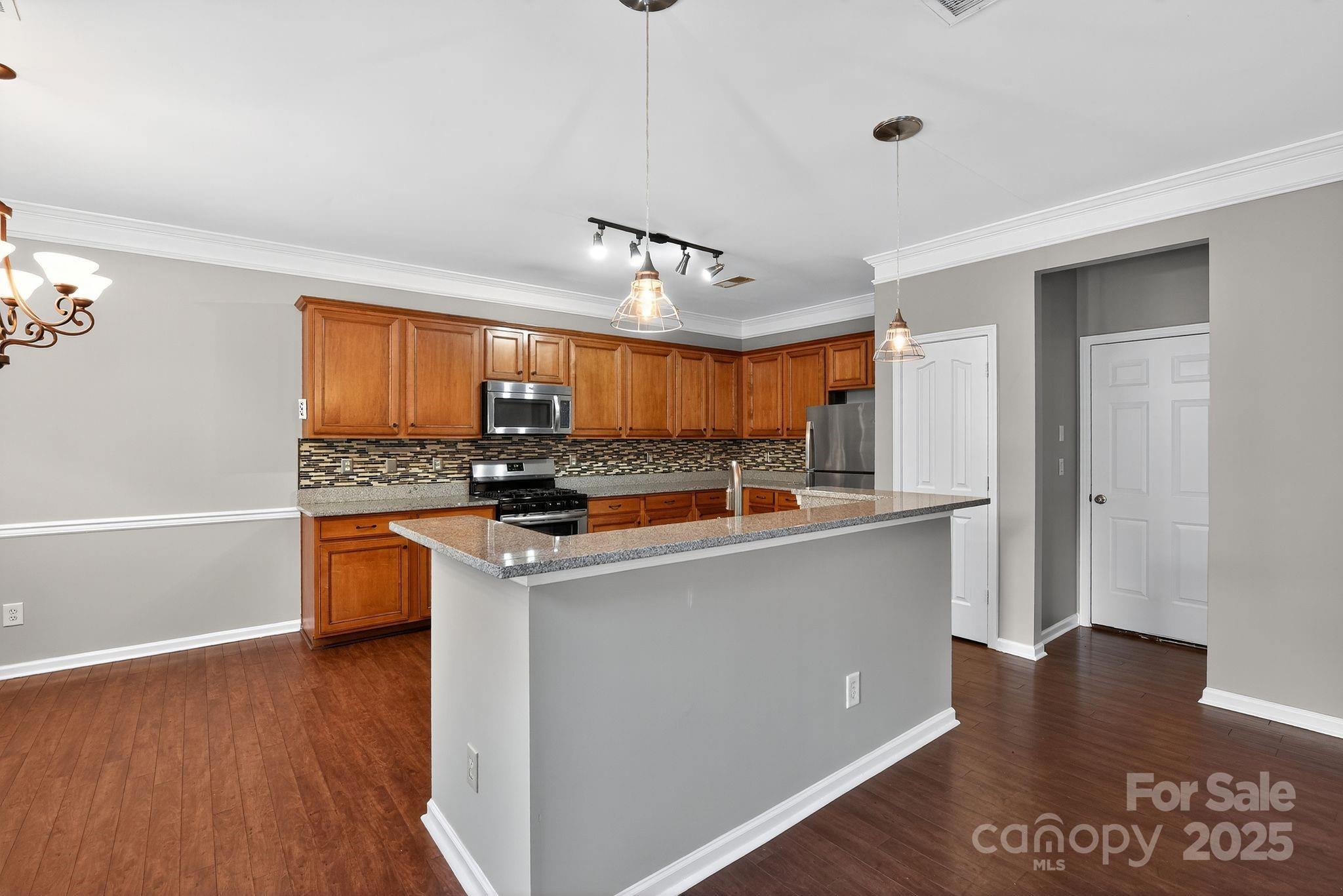 3114 Less Traveled Trail Indian Trail, NC 28079 - Photo 17 of 32 a view of kitchen with stainless steel appliances granite countertop a stove and a refrigerator