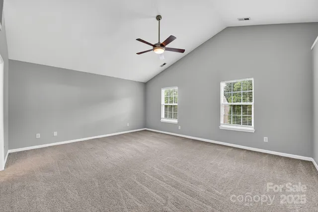 a bathroom with a granite countertop sink a toilet and a mirror