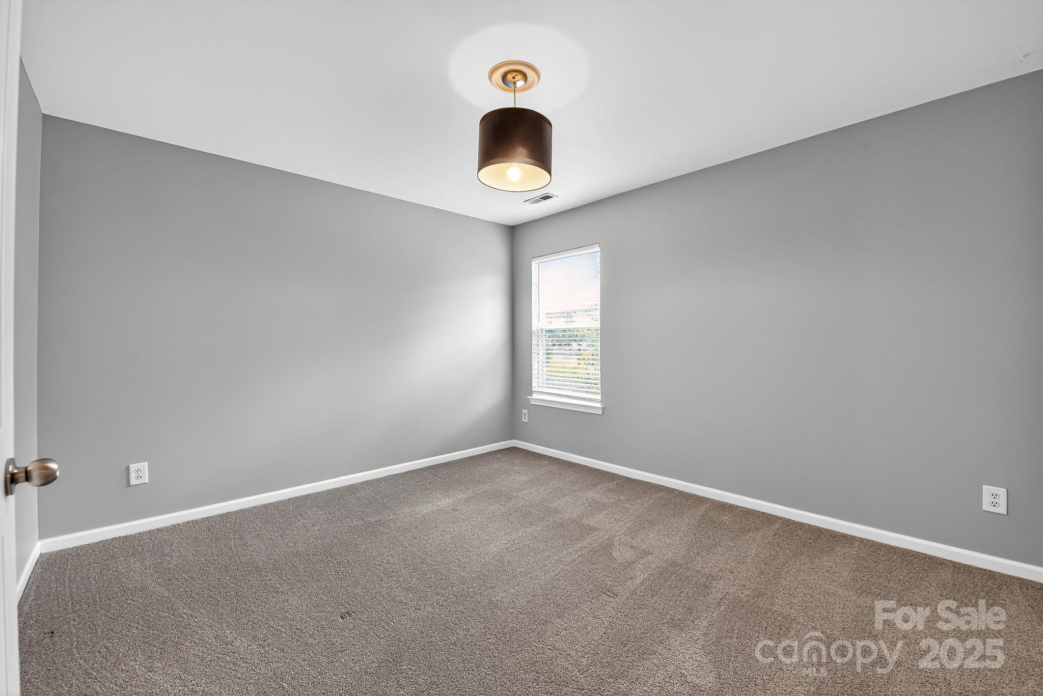 3114 Less Traveled Trail Indian Trail, NC 28079 - Photo 29 of 32 an empty room with windows and fan