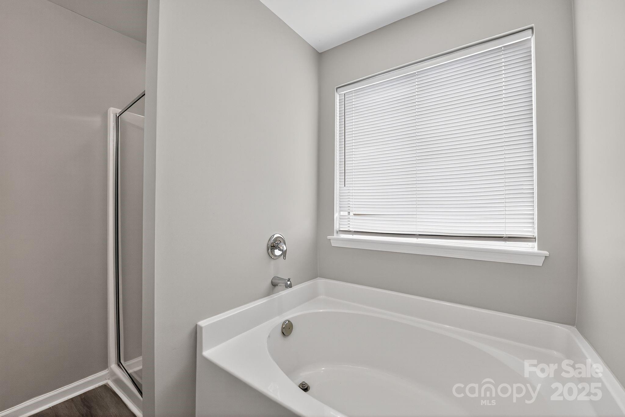 3114 Less Traveled Trail Indian Trail, NC 28079 - Photo 30 of 32 a white bath tub sitting next to a window