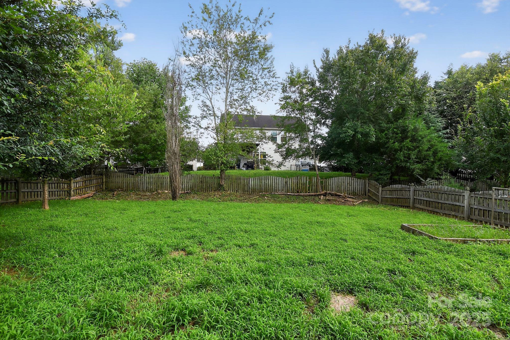 3114 Less Traveled Trail Indian Trail, NC 28079 - Photo 7 of 32 a view of a backyard with a garden