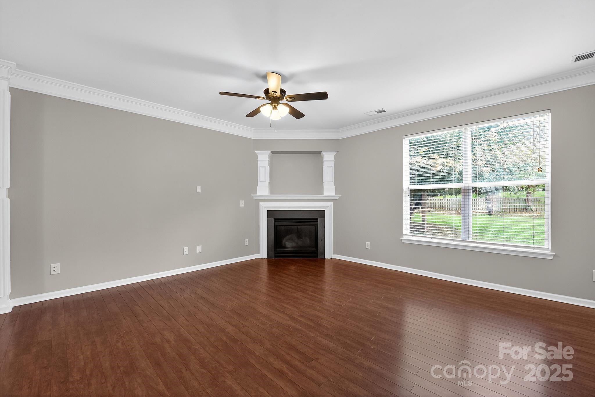 3114 Less Traveled Trail Indian Trail, NC 28079 - Photo 10 of 32 a view of an empty room with a window and fireplace