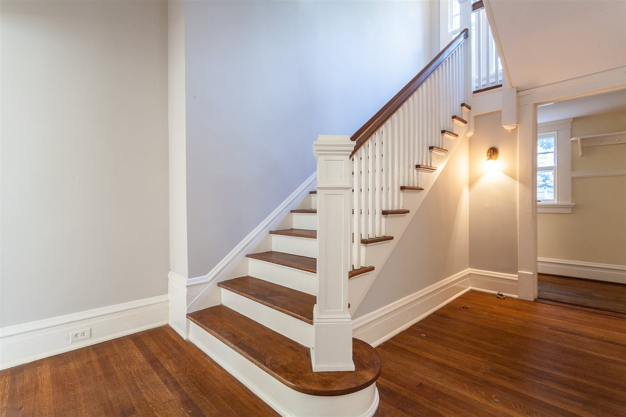 117 Forest Road Raleigh, NC 27605 - Photo 14 of 30 Hardwood Treads and Freshly Painted Foyer and Hallway Staircase to 2nd Floor