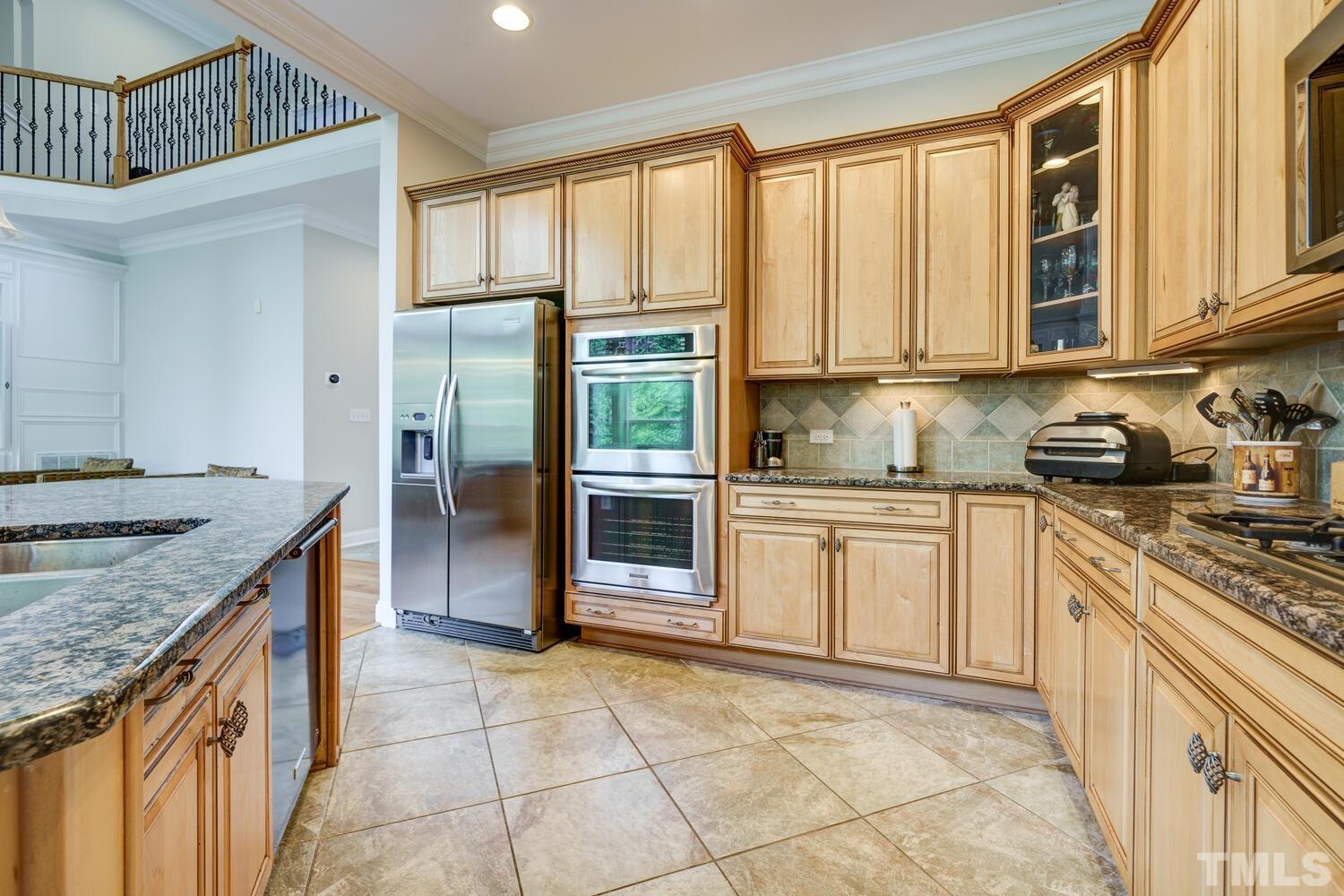 3907 Morvan Way Raleigh, NC 27612 - Photo 12 of 69 a kitchen with stainless steel appliances granite countertop a stove a sink and a refrigerator