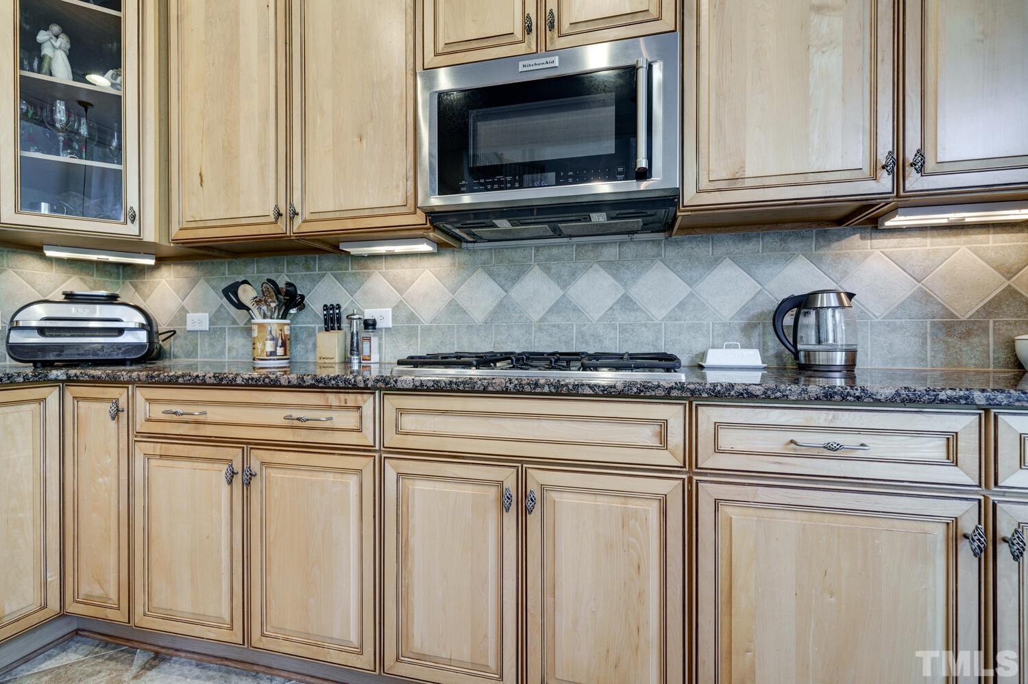 3907 Morvan Way Raleigh, NC 27612 - Photo 14 of 69 a kitchen with stainless steel appliances granite countertop a sink a stove and cabinets