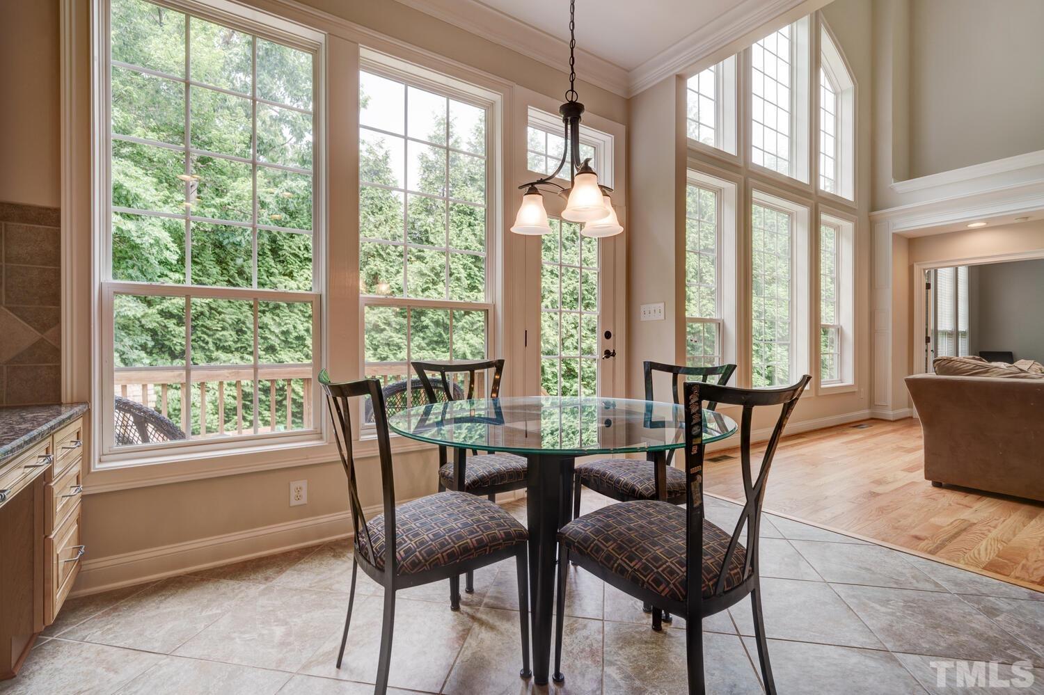 3907 Morvan Way Raleigh, NC 27612 - Photo 20 of 69 a view of a dining room with furniture large windows and wooden floor