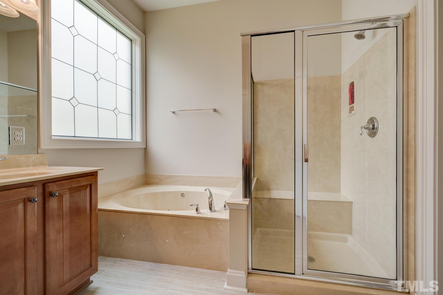 3907 Morvan Way Raleigh, NC 27612 - Photo 26 of 69 a bathroom with a bathtub and a shower