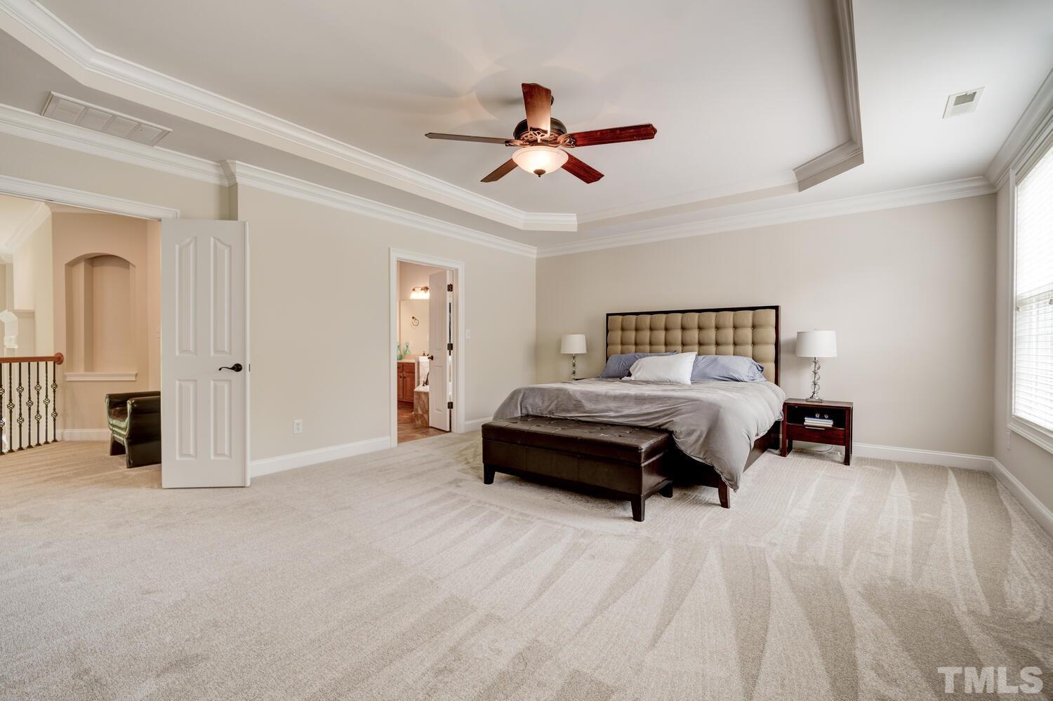 3907 Morvan Way Raleigh, NC 27612 - Photo 31 of 69 a bedroom with a bed and ceiling fan