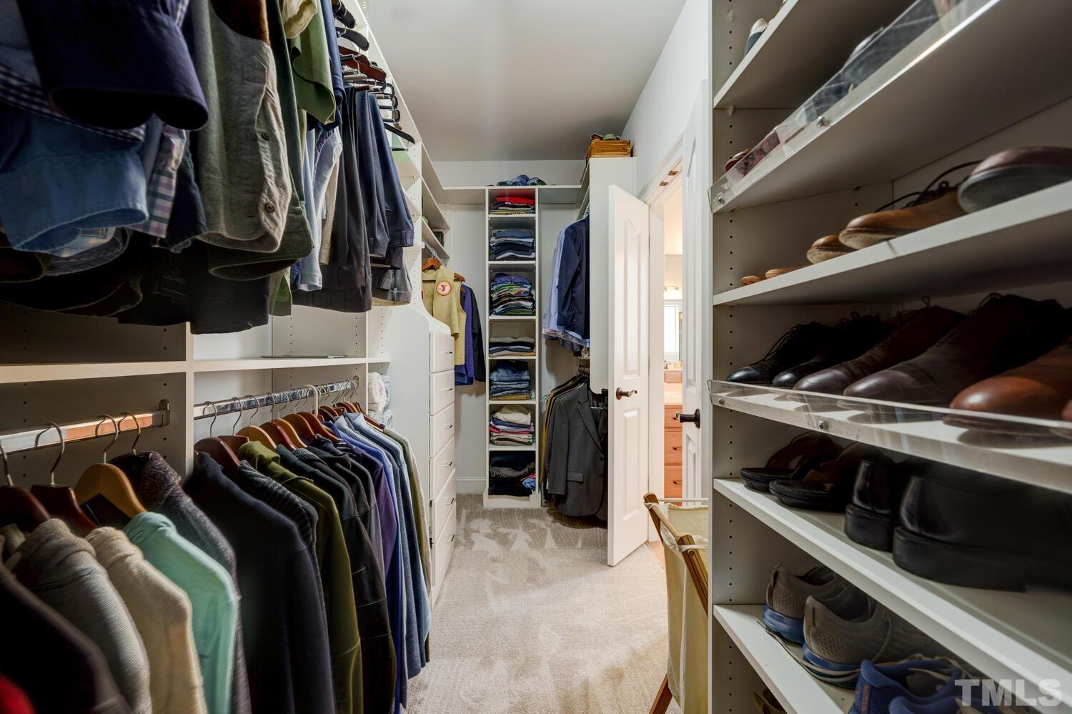 3907 Morvan Way Raleigh, NC 27612 - Photo 32 of 69 a view of walk in closet with clothes and shoes
