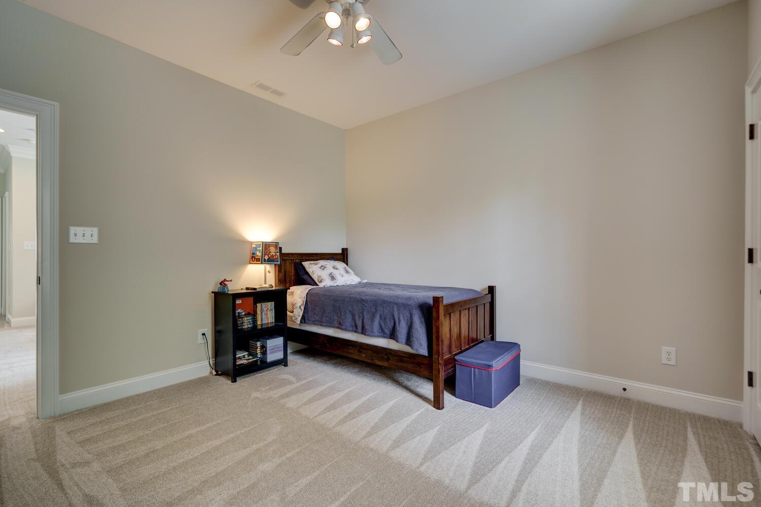 3907 Morvan Way Raleigh, NC 27612 - Photo 35 of 69 a bedroom with a bed and a table