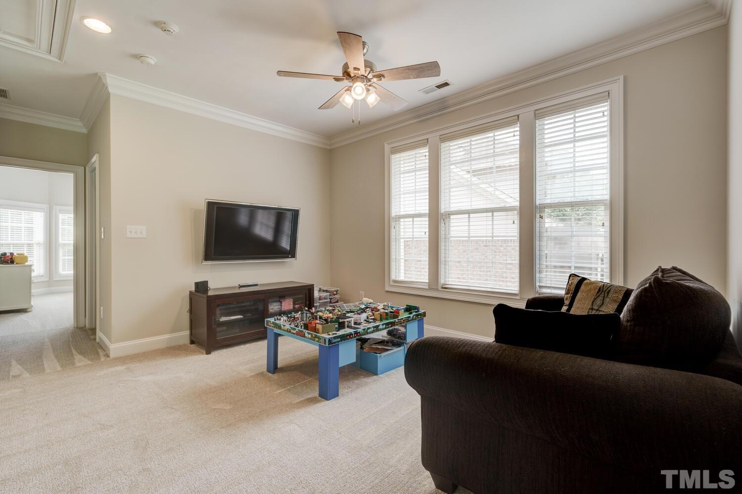 3907 Morvan Way Raleigh, NC 27612 - Photo 39 of 69 a living room with furniture and a flat screen tv