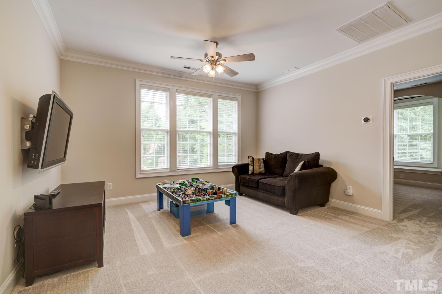 3907 Morvan Way Raleigh, NC 27612 - Photo 40 of 69 a living room with furniture and a flat screen tv