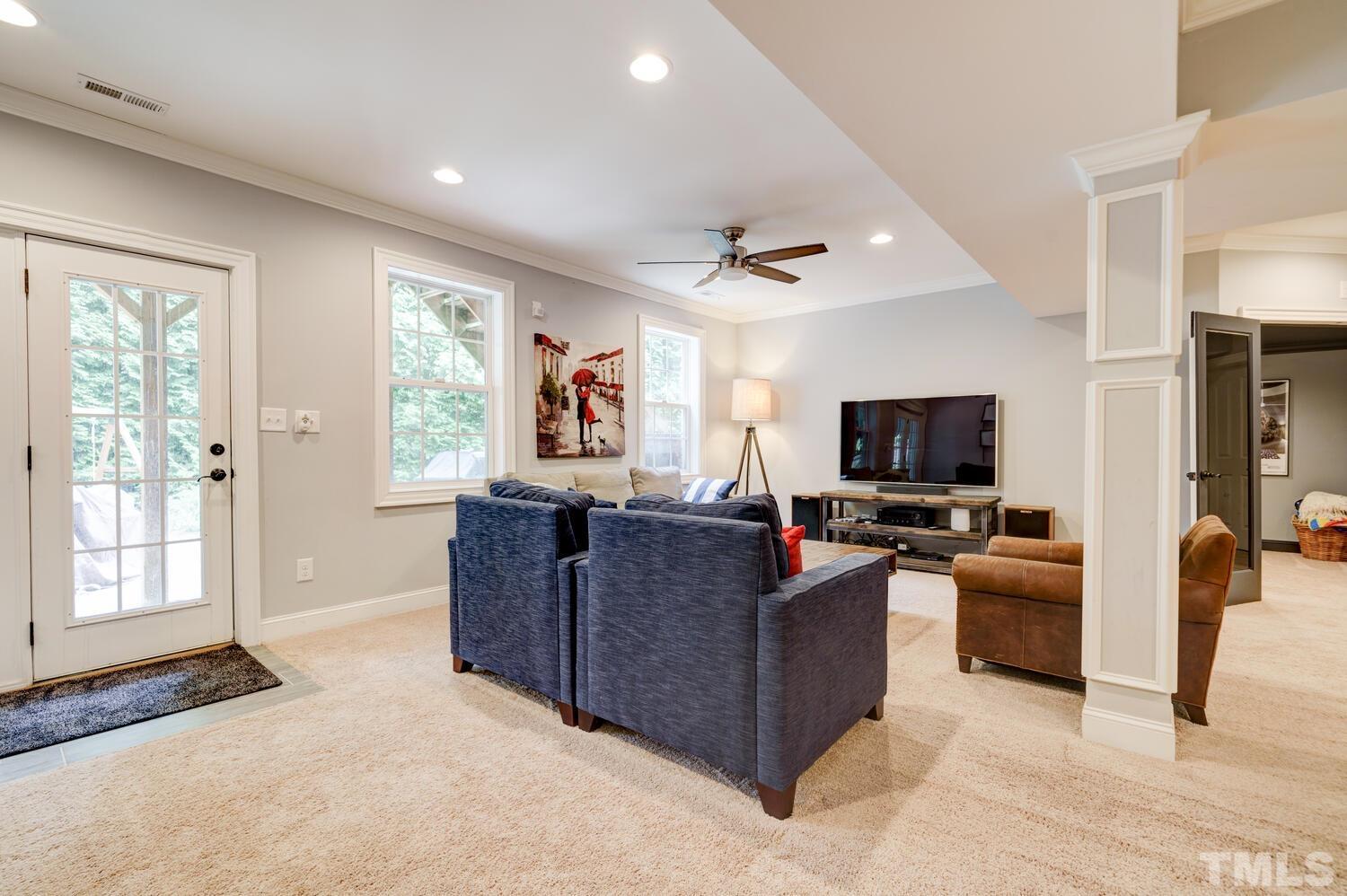 3907 Morvan Way Raleigh, NC 27612 - Photo 44 of 69 a living room with furniture and a flat screen tv