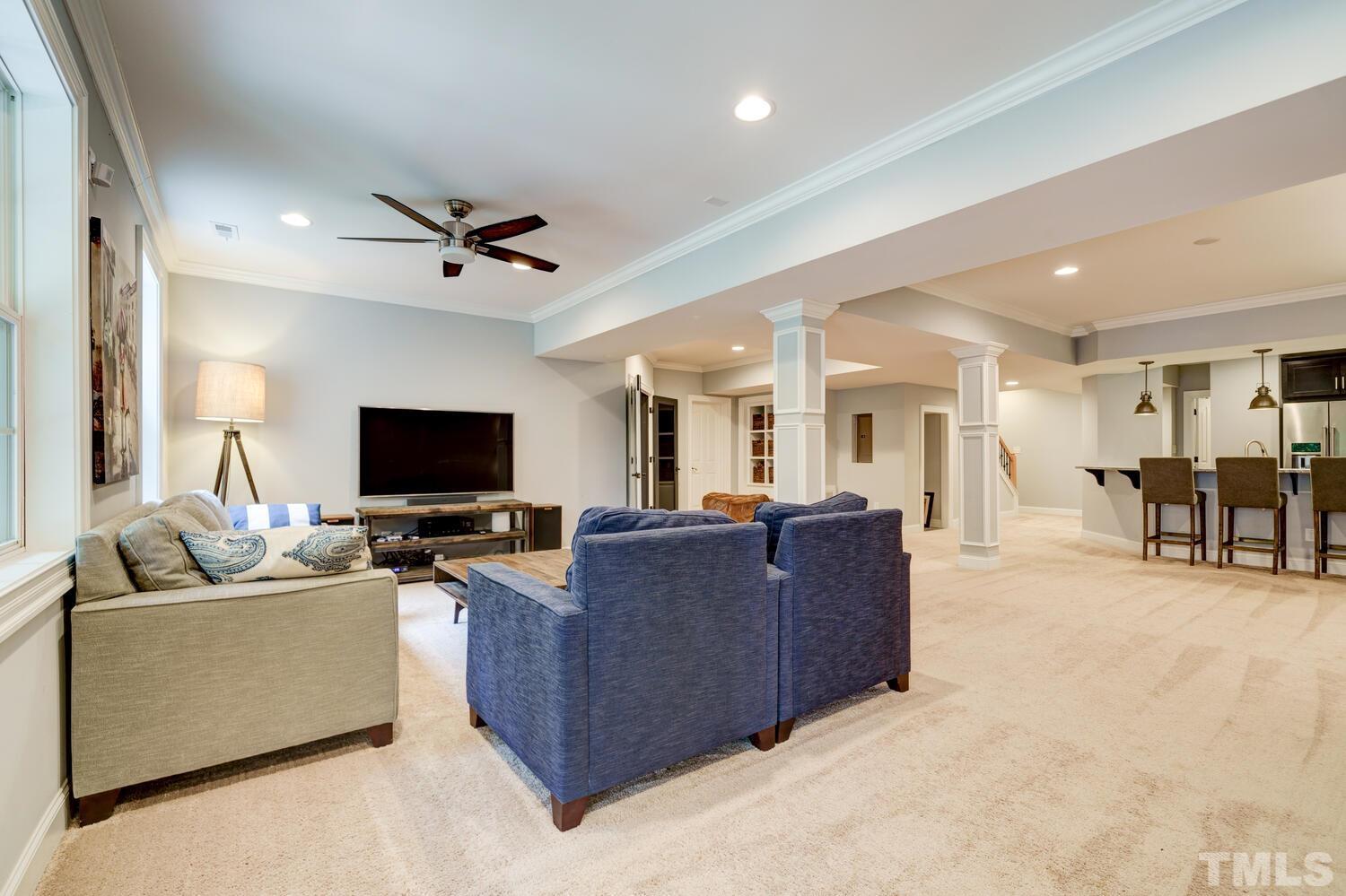 3907 Morvan Way Raleigh, NC 27612 - Photo 45 of 69 a living room with furniture and a flat screen tv