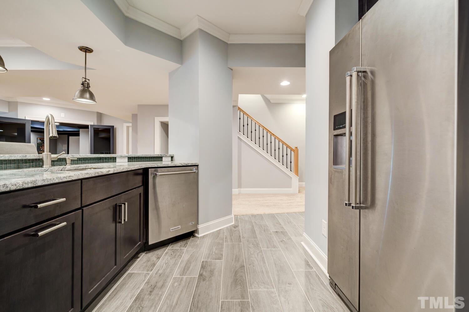 3907 Morvan Way Raleigh, NC 27612 - Photo 48 of 69 a kitchen with stainless steel appliances granite countertop a refrigerator and a sink