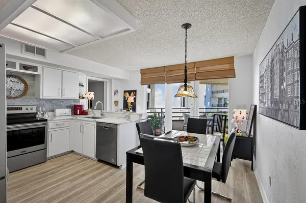 a kitchen with sink cabinets and dining table