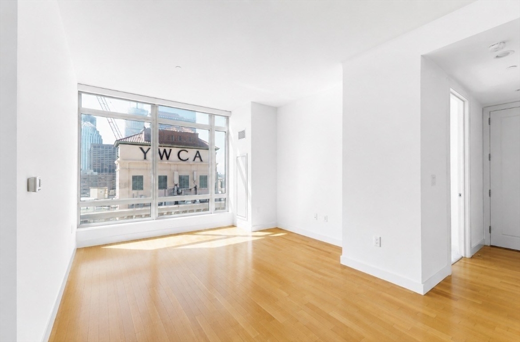 a view of a room with wooden floor
