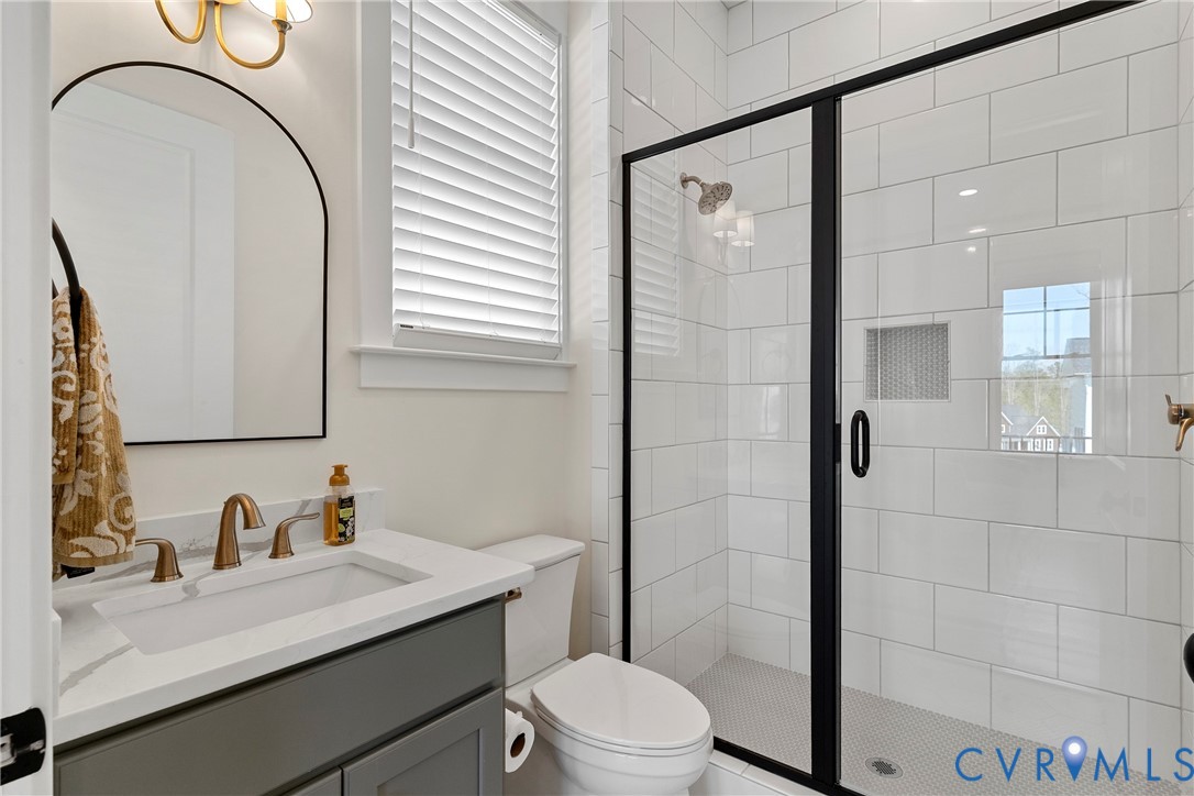5012 Lake Summer Loop Moseley, VA 23120 - Photo 35 of 67 a bathroom with a sink a toilet and shower