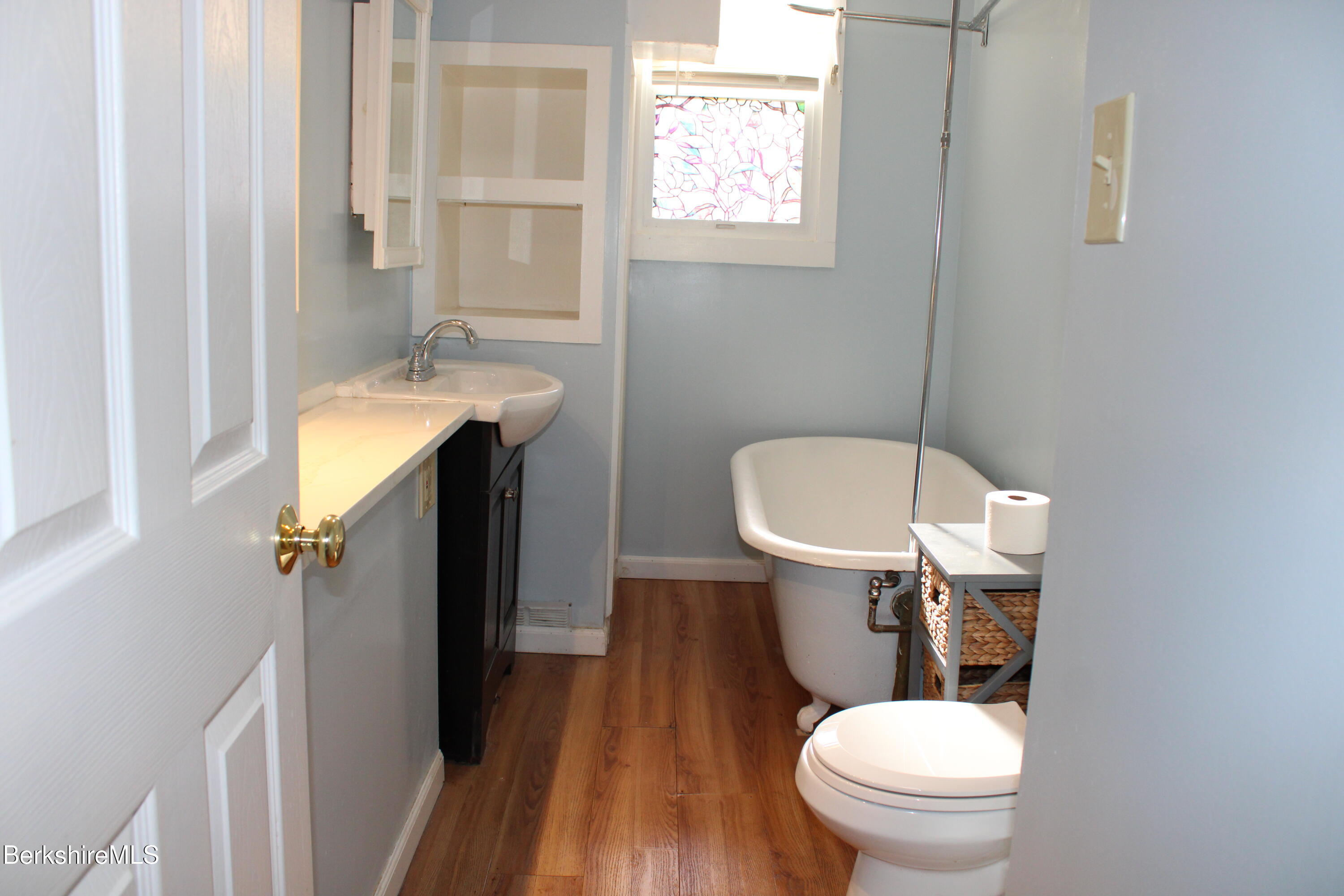3-5 Pleasant Street Pittsfield, MA 01201 - Photo 16 of 40 a bathroom with a sink a toilet and a window