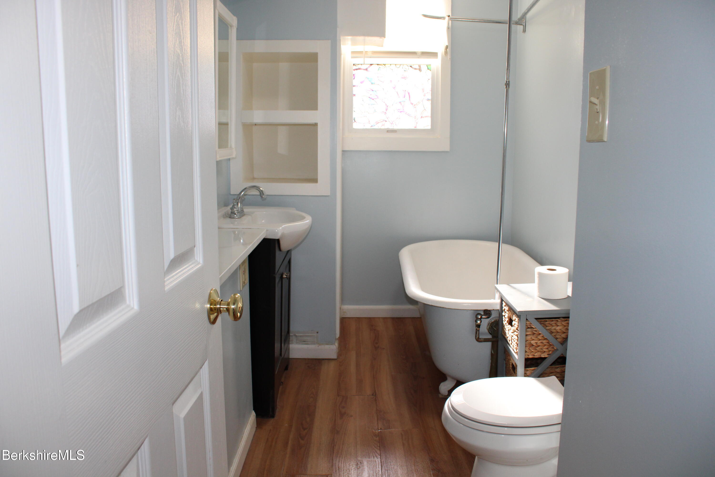 3-5 Pleasant Street Pittsfield, MA 01201 - Photo 17 of 40 a white toilet sitting next to a bathroom sink