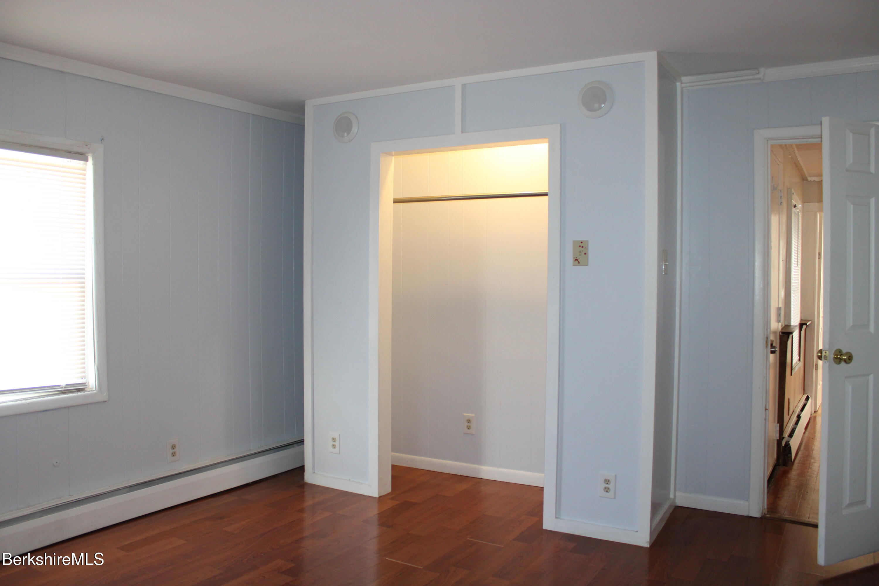 3-5 Pleasant Street Pittsfield, MA 01201 - Photo 19 of 40 a view of an empty room with wooden floor and a window