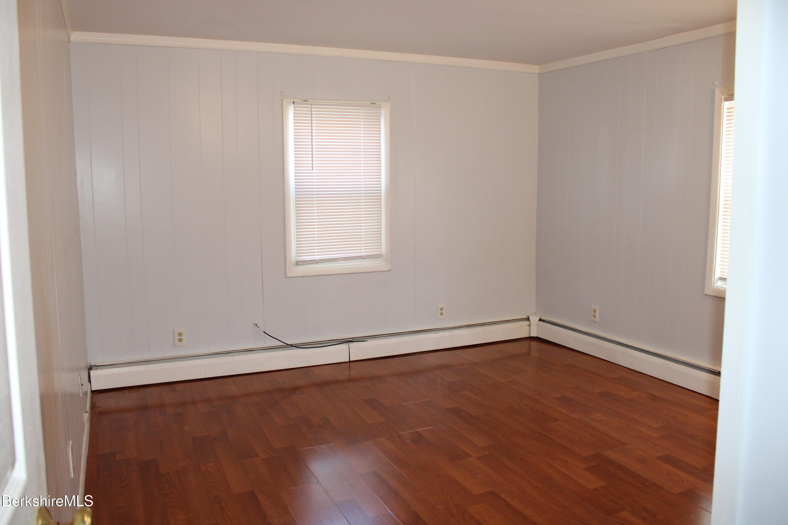 3-5 Pleasant Street Pittsfield, MA 01201 - Photo 20 of 40 an empty room with wooden floor and windows