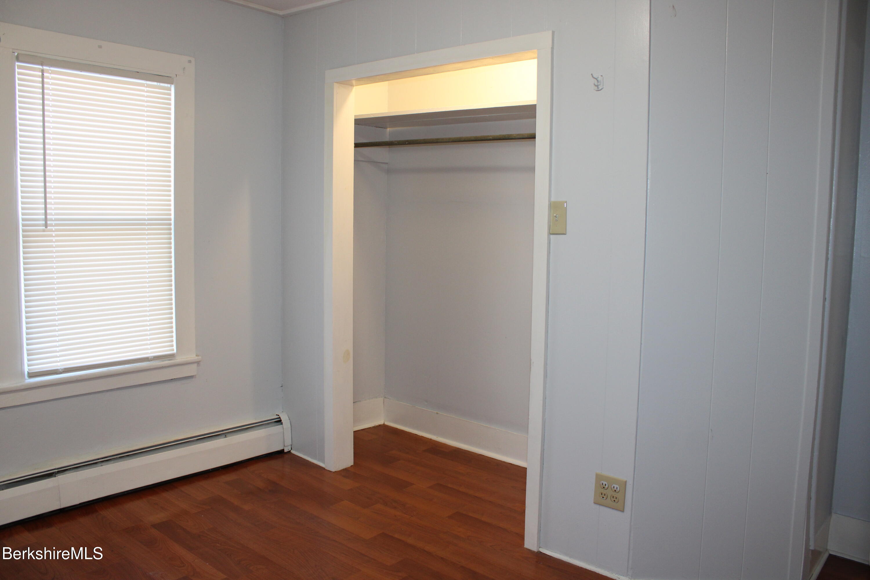 3-5 Pleasant Street Pittsfield, MA 01201 - Photo 22 of 40 an empty room with wooden floor closet and windows