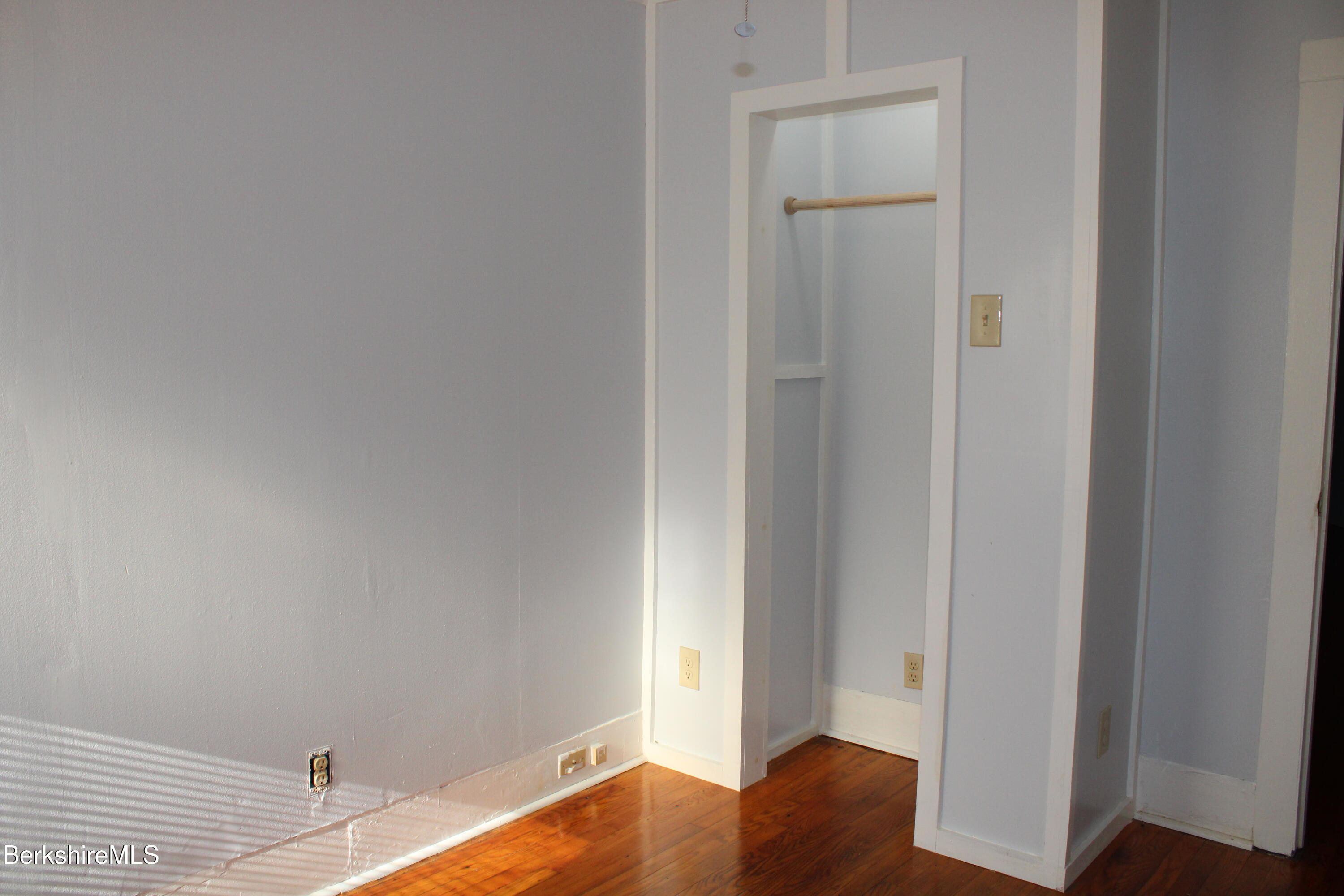 3-5 Pleasant Street Pittsfield, MA 01201 - Photo 24 of 40 a view of bedroom with a bed and wooden floor