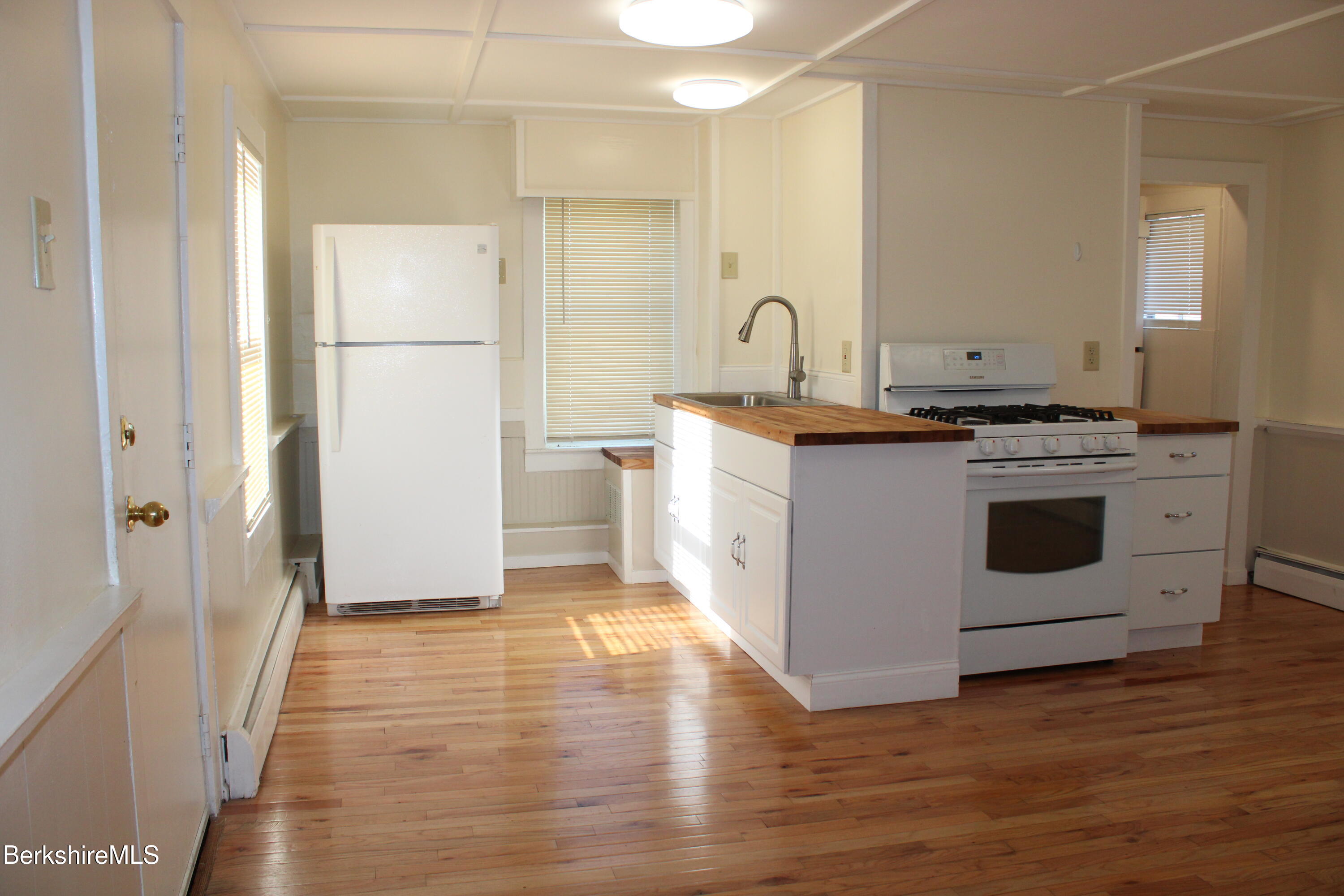 3-5 Pleasant Street Pittsfield, MA 01201 - Photo 25 of 40 a kitchen with a stove top oven sink and refrigerator