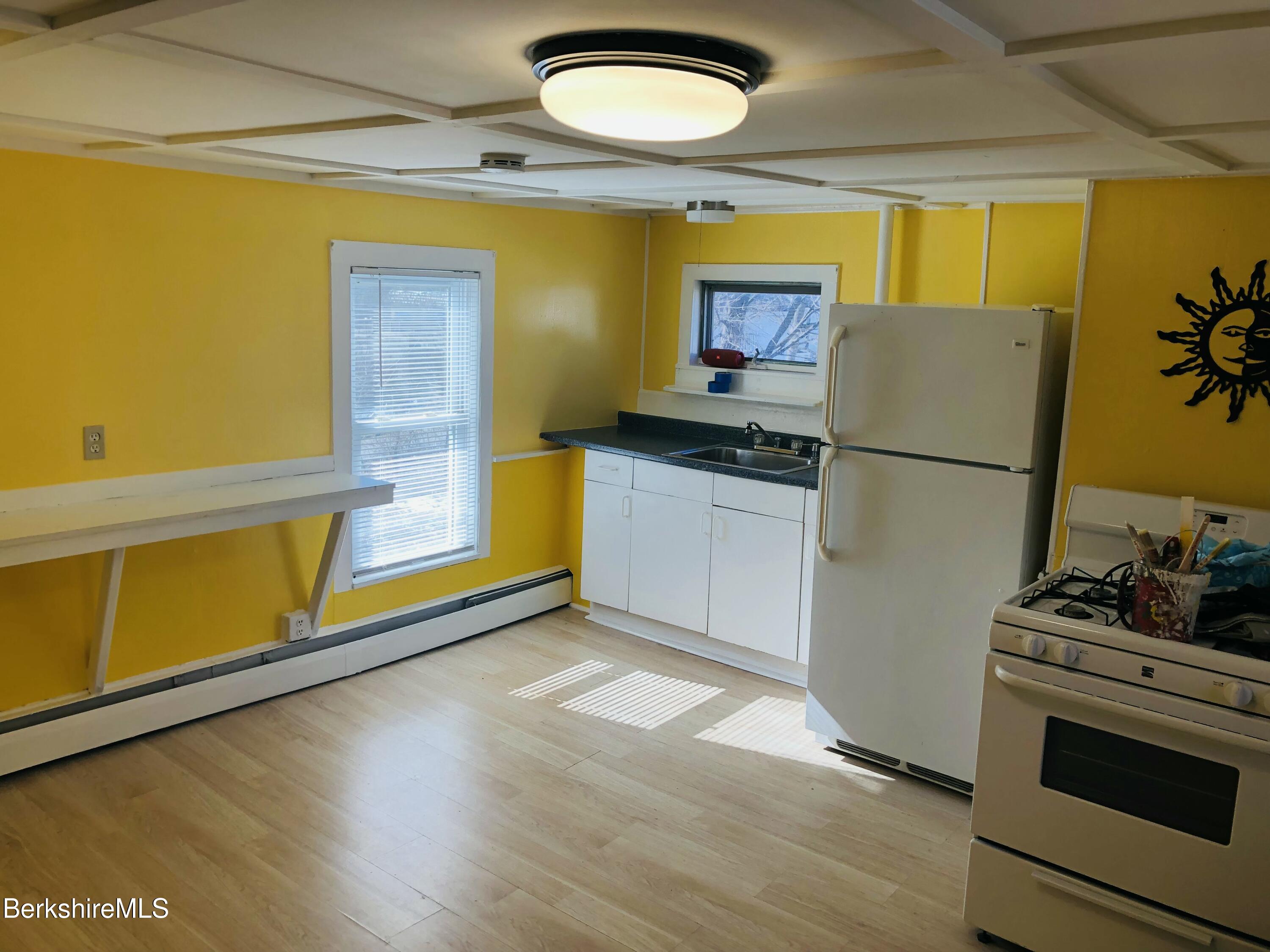 3-5 Pleasant Street Pittsfield, MA 01201 - Photo 27 of 40 a kitchen with a refrigerator and a stove