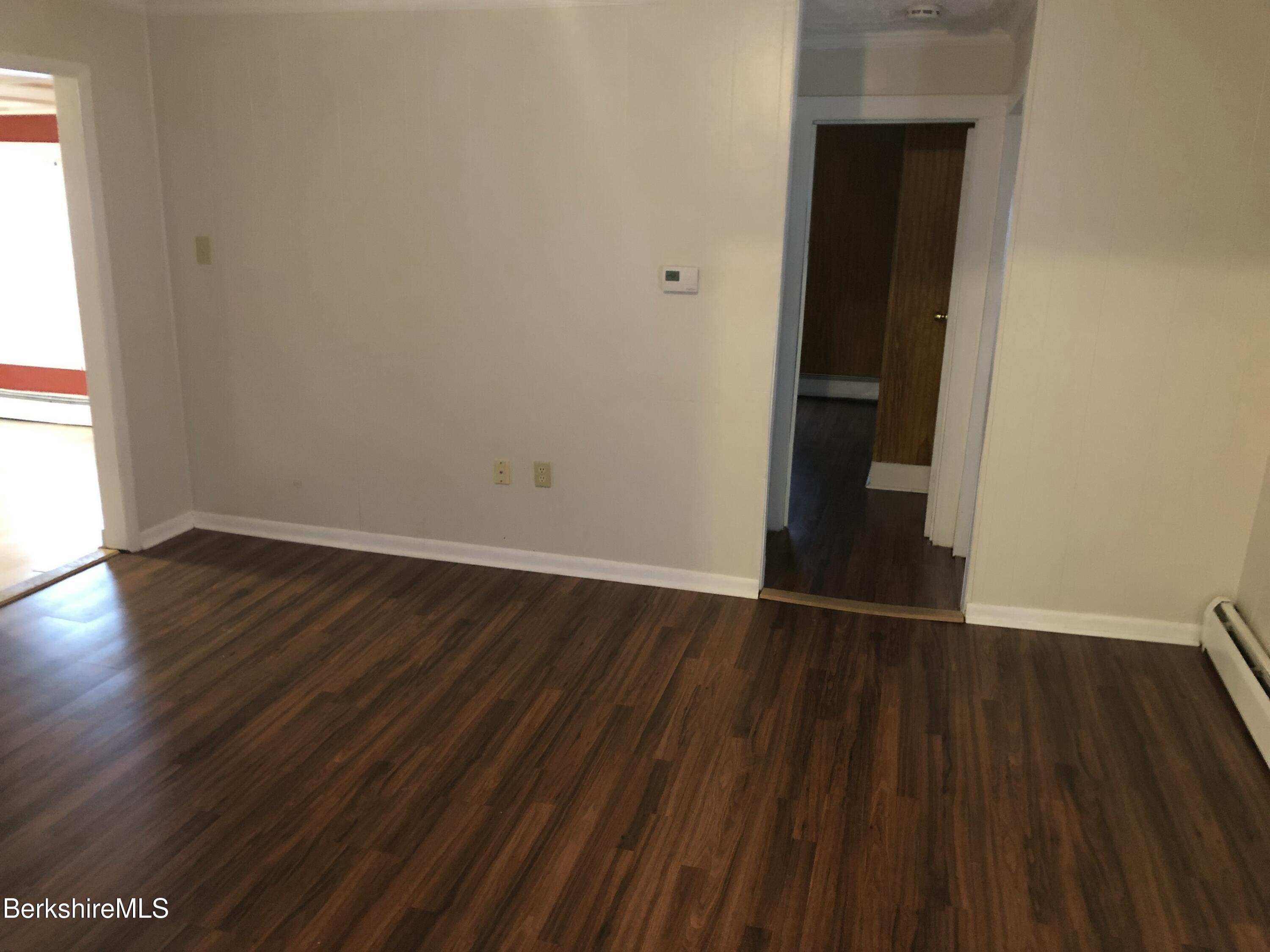 3-5 Pleasant Street Pittsfield, MA 01201 - Photo 29 of 40 a view of an empty room with wooden floor and a window