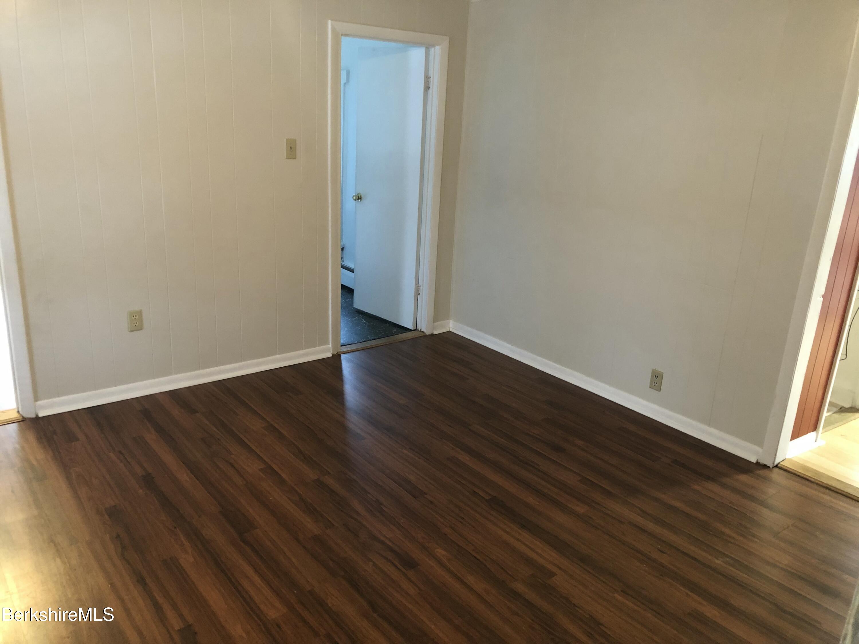 3-5 Pleasant Street Pittsfield, MA 01201 - Photo 30 of 40 a view of an empty room with wooden floor and a window