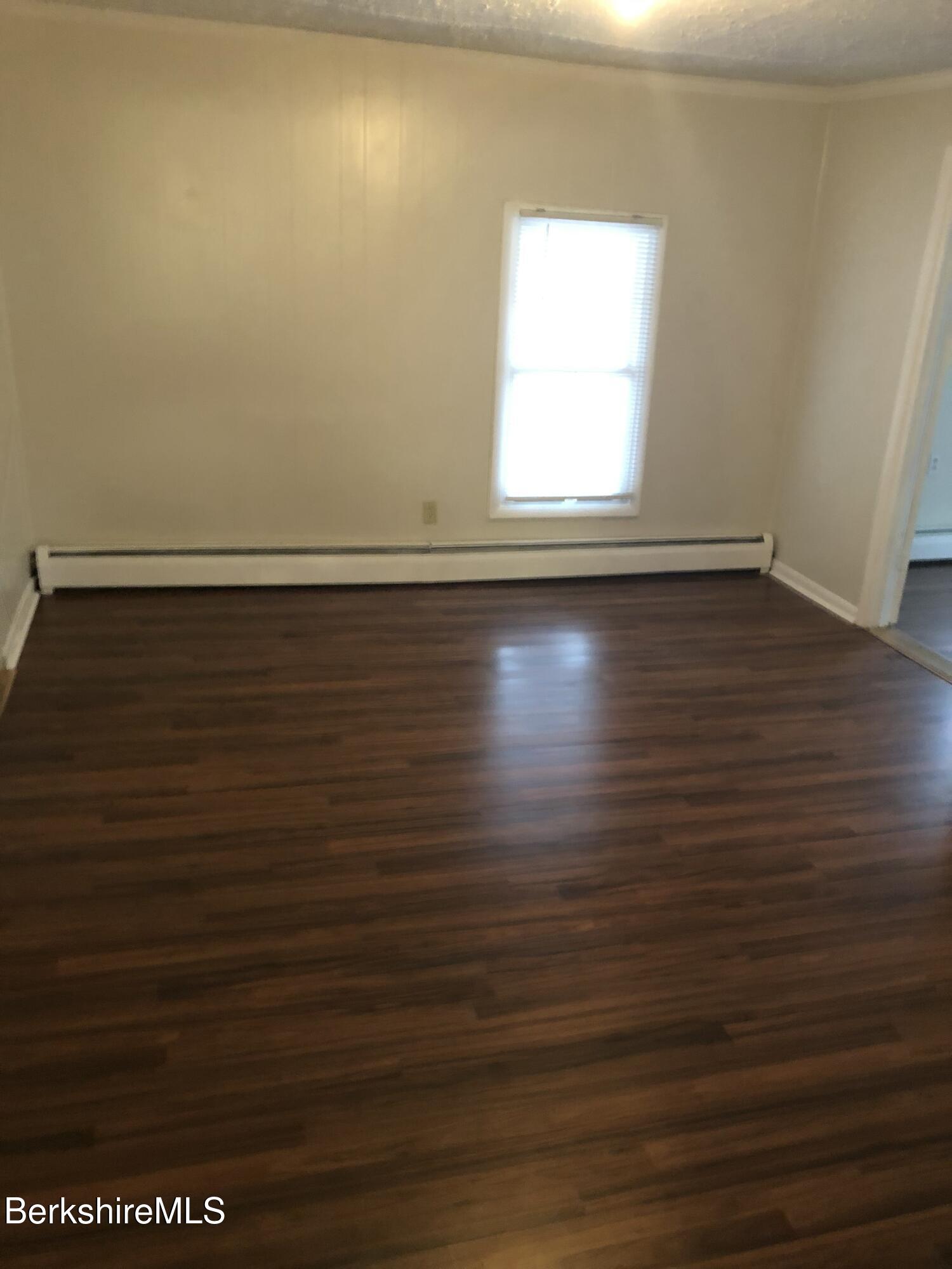 3-5 Pleasant Street Pittsfield, MA 01201 - Photo 32 of 40 an empty room with wooden floor and windows