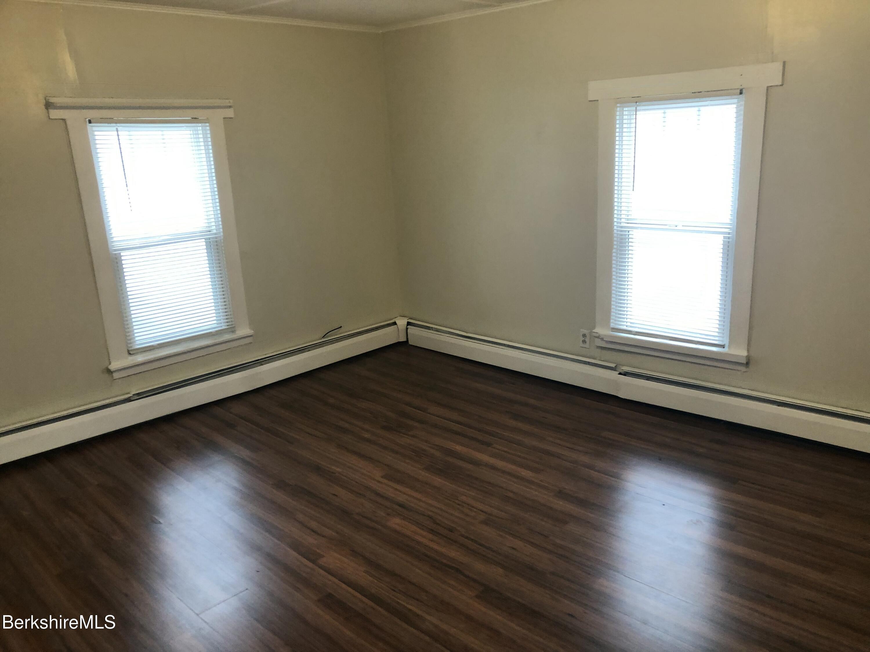 3-5 Pleasant Street Pittsfield, MA 01201 - Photo 34 of 40 an empty room with wooden floor and windows